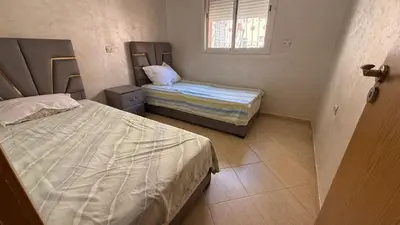a room with two beds and a window at Atlas view apartement in Marrakech