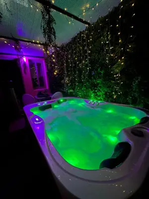 a green bath tub with lights in a room at Majorelle green Spa Suite in Marrakech