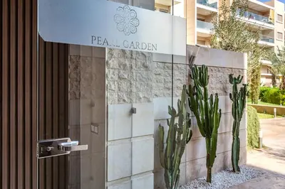 a sign for a hotel with cactuses in front of a building at Luxury Pool View Marrakech in Marrakech