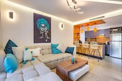 a living room with a couch and a table at Luxury Pool View Marrakech in Marrakech