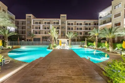 a hotel with a swimming pool at night at Luxury Pool View Marrakech in Marrakech