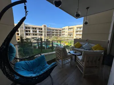 a porch with a hammock and a couch on a balcony at Luxury Pool View Marrakech in Marrakech