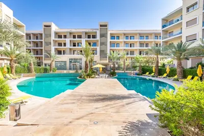 a swimming pool in front of a building at Luxury Pool View Marrakech in Marrakech
