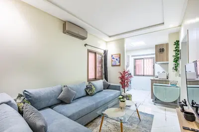 a living room with a blue couch and a table at Harmony Elegance and Comfort near Gueliz in Marrakech
