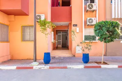 two blue vases with trees in front of a building at Harmony Elegance and Comfort near Gueliz in Marrakech