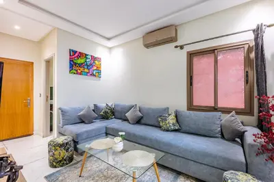 a living room with a blue couch and a table at Harmony Elegance and Comfort near Gueliz in Marrakech