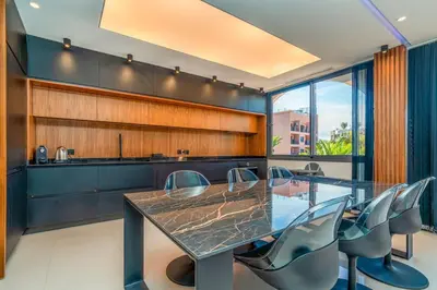 a dining room with a glass table and chairs at Luxury Apartment in Central Hivernage in Marrakech