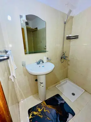 a bathroom with a sink and a shower with a mirror at Soman Marrakech in Marrakech
