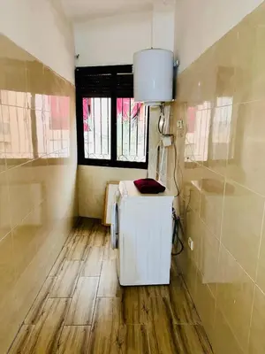 a room with a small refrigerator and a window at Soman Marrakech in Marrakech