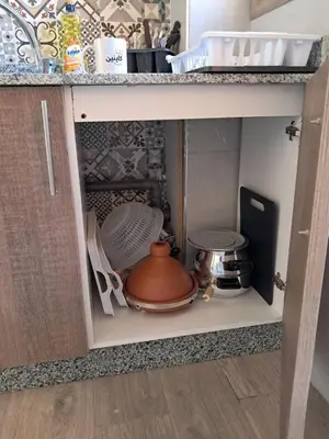 a kitchen cabinet with a tea pot and other kitchen utensils at comfortable stay in Marrakesh in Marrakech