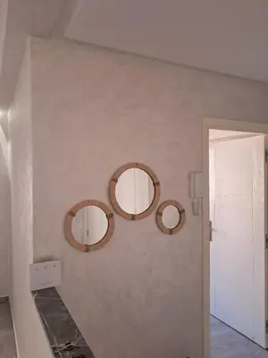 three mirrors on a wall in a room at comfortable stay in Marrakesh in Marrakech