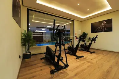 a gym with treadmills and exercise bikes in a room at New Apartment in Gueliz with Private Terrace in Marrakech