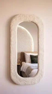 a mirror hanging on a wall with a bed at New Apartment in Gueliz with Private Terrace in Marrakech