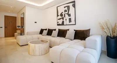 a living room with two white couches and a table at New Apartment in Gueliz with Private Terrace in Marrakech
