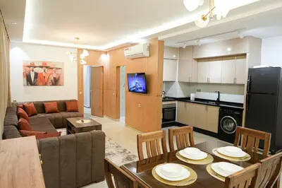 a kitchen and a living room with a table and chairs at The Skybox your private seat at the city s show in Marrakech