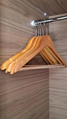 a bunch of wooden utensils are hanging on a rack at Appartement luxe avec piscine in Marrakech