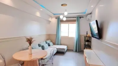 a living room with a table and a couch at A cozy escape in Marrakech in Marrakech