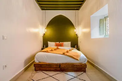 a bedroom with a bed with an arch above it at Riad JewelBox Exclusive Stay In the Medina in Marrakech