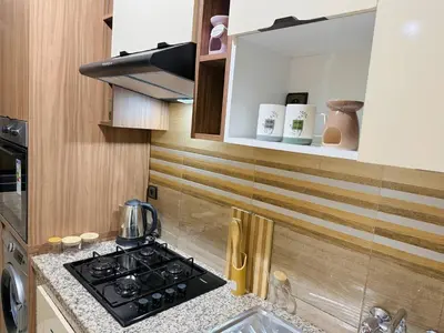 a kitchen with a stove and a counter top at Marrakech Cosy appartement 2 chambres - Confort in Marrakech