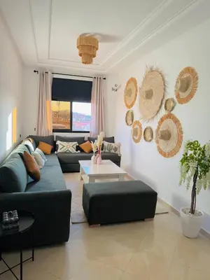 a living room with a couch and a table at Marrakech Cosy appartement 2 chambres - Confort in Marrakech