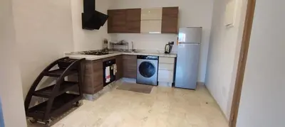 a kitchen with a refrigerator and a washing machine at Light filled Urban Retreat in Marrakech