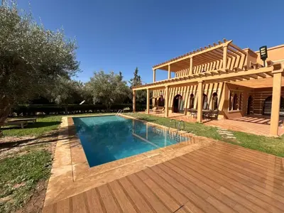 a house with a swimming pool and a wooden deck at boulevard oued issil Palmeraie in Marrakech