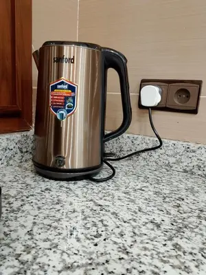 a metal kettle sitting on a counter next to a speaker at boulevard oued issil Palmeraie in Marrakech
