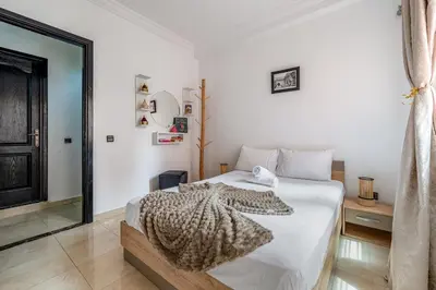 a bedroom with a bed with a blanket on it at Mabrouka apartment 10 minutes from Guéliz in Marrakech