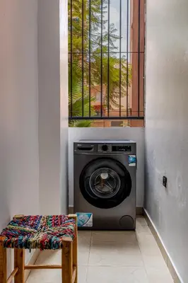 a washing machine in a room with a window at Mabrouka apartment 10 minutes from Guéliz in Marrakech