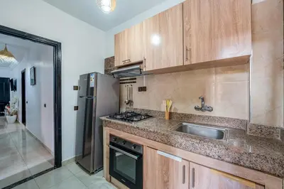 a kitchen with a sink and a refrigerator at Mabrouka apartment 10 minutes from Guéliz in Marrakech