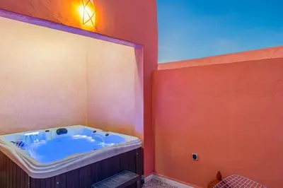 a bathroom with a tub with a large mirror at Riad Cherifa Breakfast and Jacuzzi Terrace in Marrakech