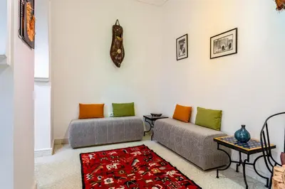 a living room with two couches and a rug at Riad Cherifa Breakfast and Jacuzzi Terrace in Marrakech
