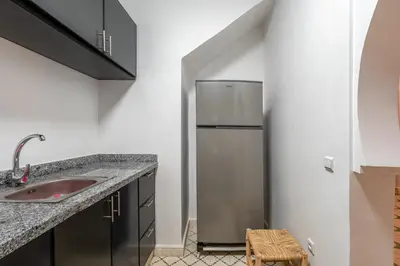 a kitchen with a refrigerator and a sink at Riad Cherifa Breakfast and Jacuzzi Terrace in Marrakech