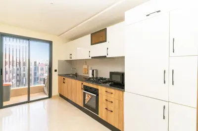 a kitchen with white appliances and a large window at Gueliz - Pool & Jacuzzi - Luxury Residence in Marrakech