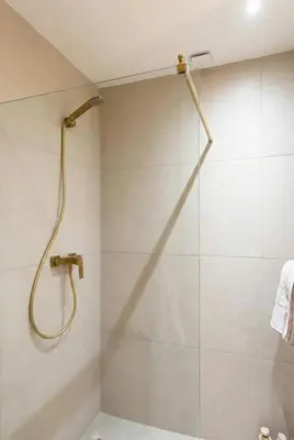 a shower with a shower head in a bathroom at Modern & Luxurious Apartment, Terrace with panoramic view of Gueliz in Marrakech