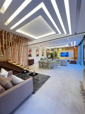 a large living room with a couch and tables at Villa luxe, tranquillité aux portes de Marrakech in Marrakech