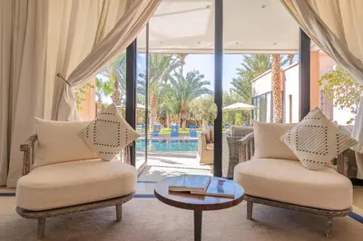 a living room with two chairs and a table at Resort Batoul nor marrakech in Marrakech