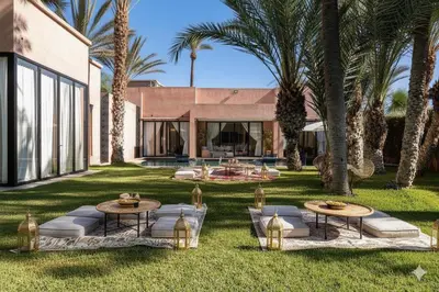 a backyard with two tables and palm trees at Resort Batoul nor marrakech in Marrakech
