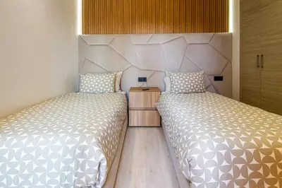 two beds sitting next to each other in a bedroom at Marrakech golf Prestigia Jade in Marrakech