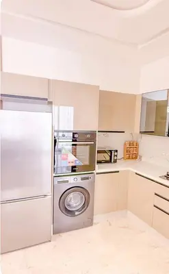 a kitchen with a washer and a dishwasher at Studio haut standing in Marrakech