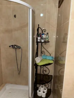 a shower in a bathroom with a glass shower stall at Hivernage Marrakech in Marrakech