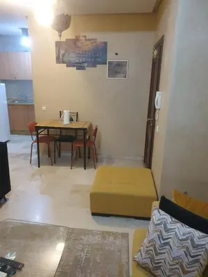 a living room with a table and a couch at Hivernage Marrakech in Marrakech