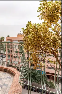 a balcony with a tree and a building at Studio Nahellan in Marrakech
