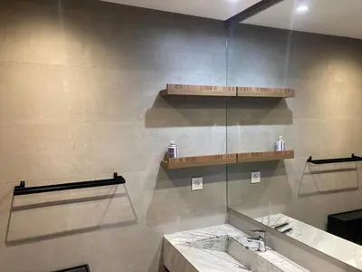 a bathroom with a sink and a mirror and shelves at Perfect condo for tourists in semlalia in Marrakech