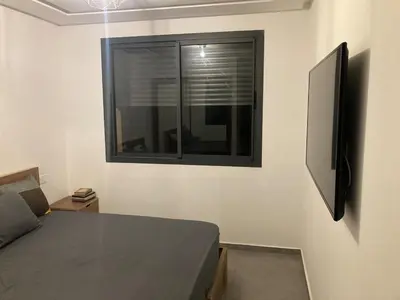 a bedroom with a window and a bed and a couch at Perfect condo for tourists in semlalia in Marrakech