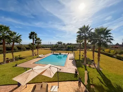 an overhead view of a swimming pool with palm trees at Exceptional Villa Private Pool - Ourika Road in Marrakech