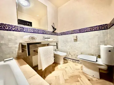 a bathroom with a toilet and a sink and a tub at Elegant Cocoon 2 Bedrooms, Pool & Rooftop in Marrakech