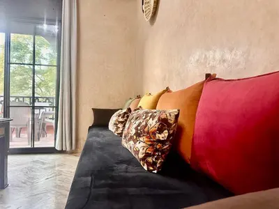 a couch with colorful pillows in a living room at Elegant Cocoon 2 Bedrooms, Pool & Rooftop in Marrakech