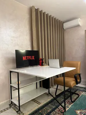 an office desk with a netflix laptop on it at Marrakech Airport in Marrakech