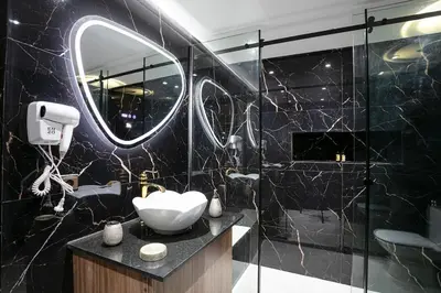 a black bathroom with a sink and a mirror at Pause in the City - Duplex - Marrakech Centre in Marrakech